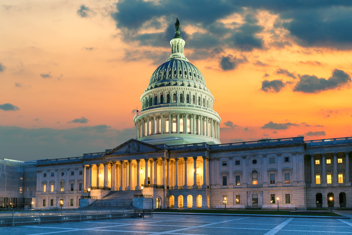 The United States Capitol Building in Washington DC at Sunset US Capitol Building at sunset with American flags is the home of the United States Congress in Washington D.C, USA.